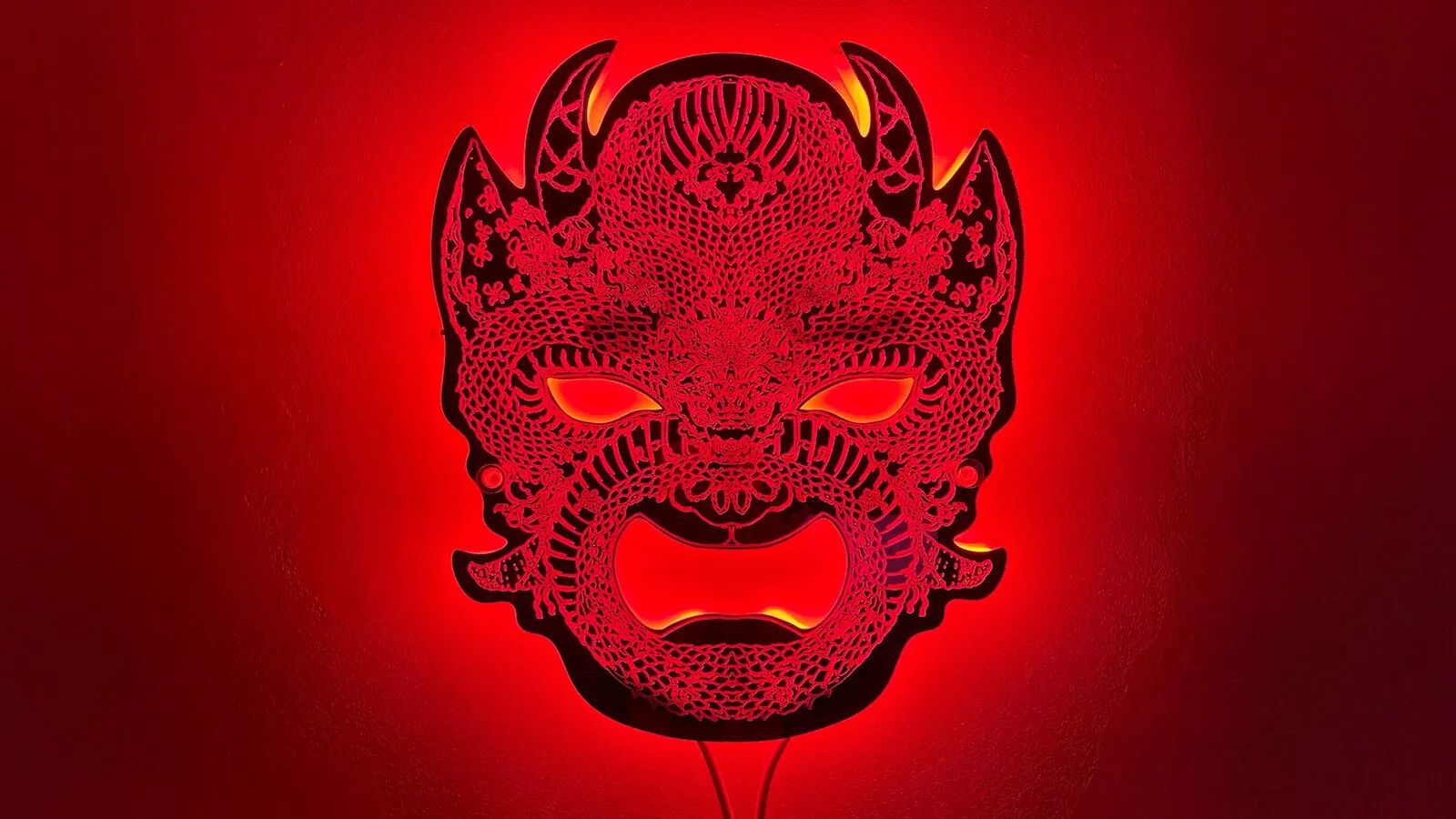 Neon Demon — laser-cut clear acrylic mask with pink neon backing, by Christina Welzer